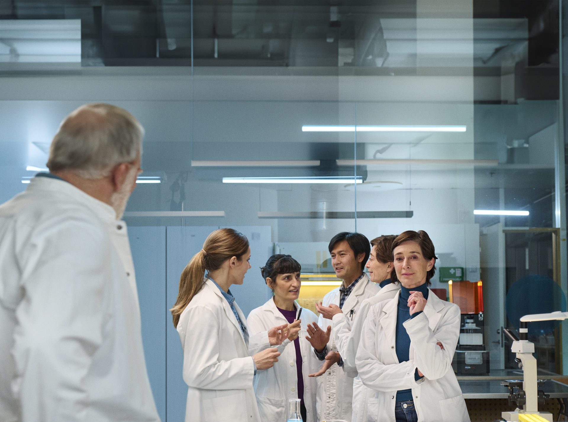 Scientists conversing in a laboratory setting