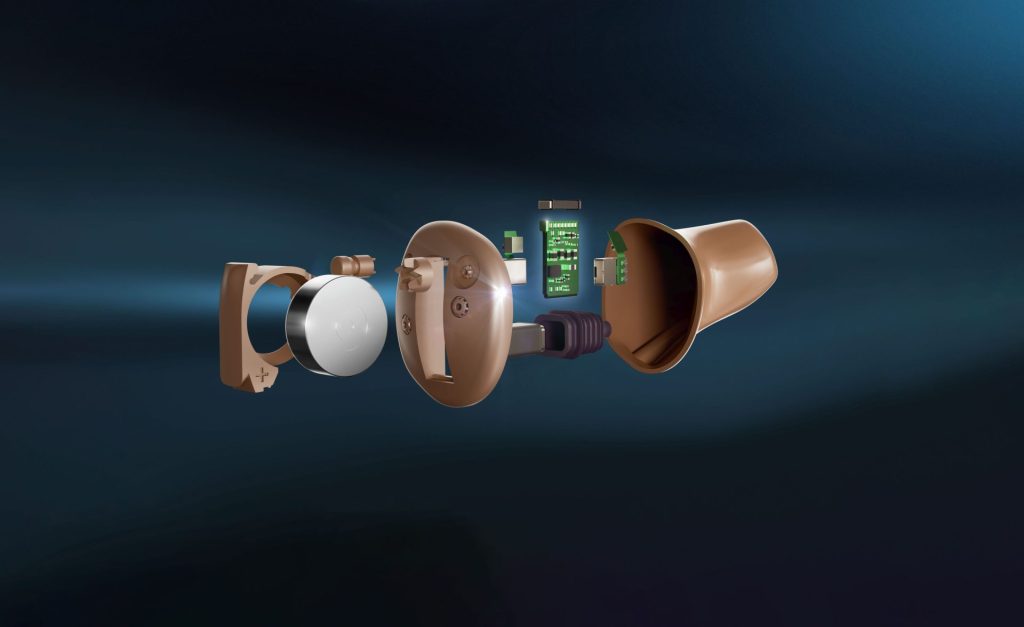 Exploded view of brown hearing aid components.